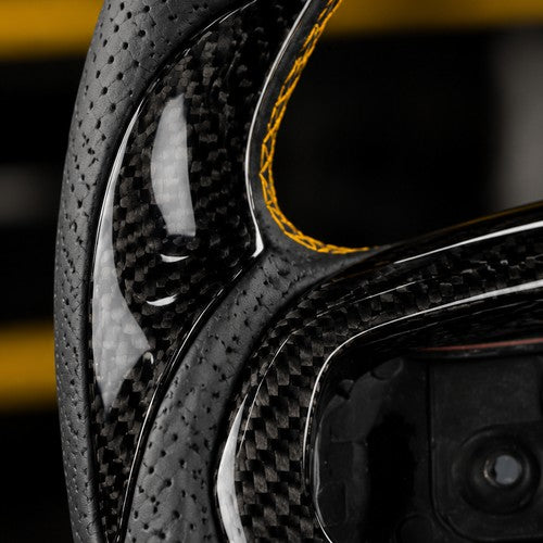 Carbon fiber thumb insert detail on the steering wheel rim